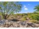 A backyard view with desert landscaping, comfortable lounge chairs, and serene surroundings at 37308 N 100Th Pl, Scottsdale, AZ 85262