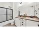 Lovely bathroom featuring double sink vanity, granite counters, framed mirror, and shower at 37308 N 100Th Pl, Scottsdale, AZ 85262