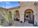 Gated entry leads to home's front door through an arched courtyard at 37308 N 100Th Pl, Scottsdale, AZ 85262