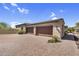 Wide driveway leads to a three-car garage on desert home at 37308 N 100Th Pl, Scottsdale, AZ 85262