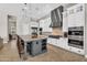 Gourmet kitchen with stainless steel appliances, center island, and ample cabinet space at 37308 N 100Th Pl, Scottsdale, AZ 85262
