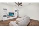 Open living room with modern decor, hardwood floors, and a large sofa provides ample space at 37308 N 100Th Pl, Scottsdale, AZ 85262