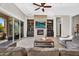 Inviting living room with fireplace, entertainment center, and sliding glass doors to the outside at 37308 N 100Th Pl, Scottsdale, AZ 85262