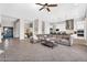 Open living space with large sectional, tile floors, and access to backyard at 37308 N 100Th Pl, Scottsdale, AZ 85262