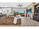 Spacious living room with fireplace, large sectional couch, and access to the backyard at 37308 N 100Th Pl, Scottsdale, AZ 85262