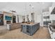 Open-concept living room with large kitchen island, fireplace, and access to backyard at 37308 N 100Th Pl, Scottsdale, AZ 85262