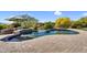Inviting pool with an attached spa and luxurious outdoor lounging area at 37308 N 100Th Pl, Scottsdale, AZ 85262
