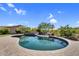 Sparkling pool and spa surrounded by lush landscaping with an outdoor BBQ and lounging area at 37308 N 100Th Pl, Scottsdale, AZ 85262