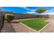 This backyard boasts a well-maintained lawn and rock features, perfect for outdoor enjoyment at 3907 E Archer Dr, San Tan Valley, AZ 85140