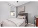 This bedroom features a plush bed, neutral tones, and a bright window with serene neighborhood views at 3907 E Archer Dr, San Tan Valley, AZ 85140