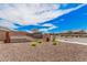 A welcoming Archer Meadows community entrance, landscaped with colorful flowers and desert plants under a bright blue sky at 3907 E Archer Dr, San Tan Valley, AZ 85140