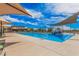 Gorgeous community pool with crystal clear water, a splash pad, shaded seating, and ample space for relaxation at 3907 E Archer Dr, San Tan Valley, AZ 85140