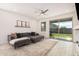 Bright living room with a sliding glass door to the backyard, a comfortable sofa, and stylish decor at 3907 E Archer Dr, San Tan Valley, AZ 85140