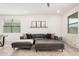 Modern living room with a neutral color scheme, plush seating, and large windows for ample natural light at 3907 E Archer Dr, San Tan Valley, AZ 85140