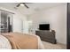 Comfortable main bedroom with a dark wood dresser and sliding barn door at 3907 E Archer Dr, San Tan Valley, AZ 85140