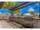 Outdoor grill area featuring stainless steel grills, granite countertops, storage, and shade structure for community gatherings at 3907 E Archer Dr, San Tan Valley, AZ 85140