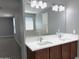 Bathroom featuring double sinks, mirror, and lighting at 4056 E Devon Dr, Gilbert, AZ 85296