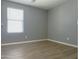 Neutral bedroom with hardwood flooring, window, and base trim at 4056 E Devon Dr, Gilbert, AZ 85296