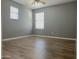 Spacious bedroom with vinyl plank floors and two windows offering ample natural light at 4056 E Devon Dr, Gilbert, AZ 85296