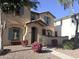Charming two-story home with a well-manicured front yard, colorful flower beds and turquoise accents at 4056 E Devon Dr, Gilbert, AZ 85296