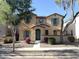 Inviting two-story home featuring colorful flower beds, a charming entryway, and turquoise shutters at 4056 E Devon Dr, Gilbert, AZ 85296