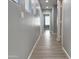 Hallway with wood-look floors, neutral paint, and doors leading to bedrooms or other areas at 4056 E Devon Dr, Gilbert, AZ 85296