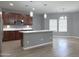 Bright kitchen featuring stainless steel appliances, island with seating, and ample cabinet space at 4056 E Devon Dr, Gilbert, AZ 85296
