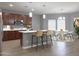 Open-concept kitchen with stainless appliances, island with seating, and adjacent dining area at 4056 E Devon Dr, Gilbert, AZ 85296