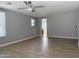 Open-concept living room featuring modern ceiling fan, and vinyl plank flooring at 4056 E Devon Dr, Gilbert, AZ 85296