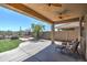 The covered back patio overlooks the low-maintenance backyard with a built-in firepit and desert landscaping at 40741 N Citrus Canyon Trl, Anthem, AZ 85086