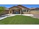 Backyard with artificial grass, patio and seating area at 40741 N Citrus Canyon Trl, Anthem, AZ 85086