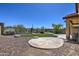 Backyard features artificial grass, gravel and concrete patio at 40741 N Citrus Canyon Trl, Anthem, AZ 85086