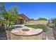 Home featuring a well maintained backyard with grass, and fountain at 40741 N Citrus Canyon Trl, Anthem, AZ 85086