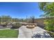 The backyard features a cozy fire pit and desert landscaping at 40741 N Citrus Canyon Trl, Anthem, AZ 85086