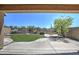 View of the backyard featuring desert landscaping, artificial grass, and a built-in fire pit area at 40741 N Citrus Canyon Trl, Anthem, AZ 85086