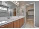 Well-lit bathroom features a double sink vanity, a large mirror, and an accessible walk-in closet at 40741 N Citrus Canyon Trl, Anthem, AZ 85086
