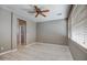 Comfortable bedroom features a ceiling fan, multiple windows, and light-colored laminate flooring at 40741 N Citrus Canyon Trl, Anthem, AZ 85086