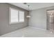 Light-filled dining room features white tile flooring, neutral walls, and modern light fixtures at 40741 N Citrus Canyon Trl, Anthem, AZ 85086