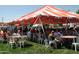 Outdoor seating area at a festival with shade and a variety of food vendors at 40741 N Citrus Canyon Trl, Anthem, AZ 85086