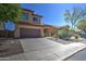 Inviting two-story home with a well-maintained lawn, desert landscaping, and a two-car garage at 40741 N Citrus Canyon Trl, Anthem, AZ 85086