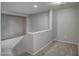 Carpeted upstairs hallway with neutral walls and ceilings, leading to additional rooms at 40741 N Citrus Canyon Trl, Anthem, AZ 85086