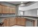 Stylish kitchen with light wood cabinets, stainless steel appliances, and tile backsplash at 40741 N Citrus Canyon Trl, Anthem, AZ 85086