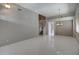 Spacious living room with tile floors, light grey walls, staircase, and a decorative light fixture at 40741 N Citrus Canyon Trl, Anthem, AZ 85086