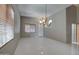 Bright living room featuring tile floors, neutral walls, a front door, and plenty of natural light at 40741 N Citrus Canyon Trl, Anthem, AZ 85086