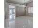 Bright and open living room with tile flooring, neutral walls and backyard access through the sliding glass doors at 40741 N Citrus Canyon Trl, Anthem, AZ 85086