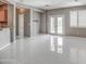 Spacious living room with bright natural light, white tile flooring, and neutral walls at 40741 N Citrus Canyon Trl, Anthem, AZ 85086