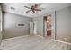 Relaxing main bedroom with ceiling fan, light wood laminate flooring and ensuite bathroom access at 40741 N Citrus Canyon Trl, Anthem, AZ 85086