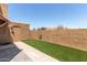 Enclosed backyard featuring artificial turf, a stucco wall, and a gated entry at 4218 S 46Th Pl, Phoenix, AZ 85040