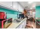 Bright kitchen featuring white cabinetry, stainless steel sink, and updated appliances at 4218 S 46Th Pl, Phoenix, AZ 85040