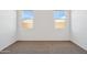 Carpeted bedroom featuring two windows at 5094 E Umber Rd, San Tan Valley, AZ 85143